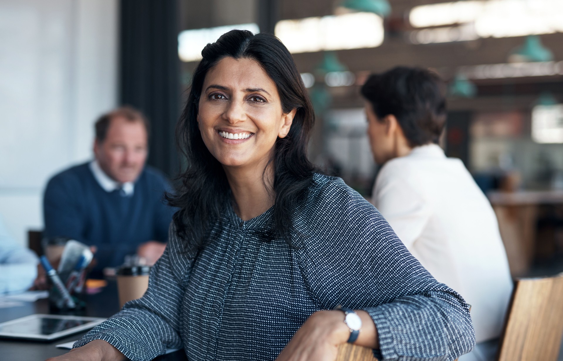 Portrait of a mature businesswoman having a meeting with her team in a modern office